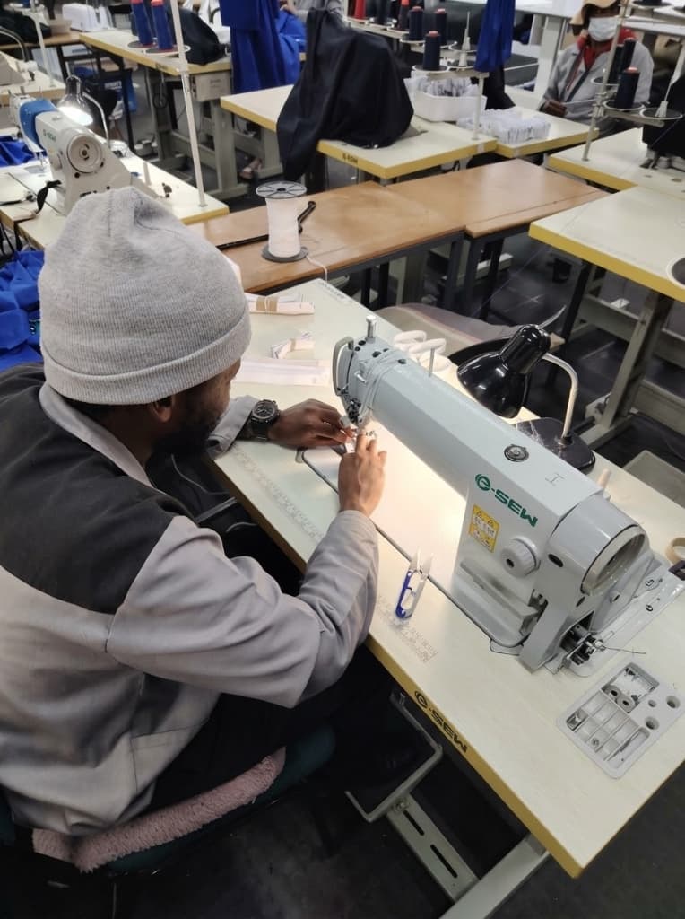 H&M machinist at an industrial sewing machine