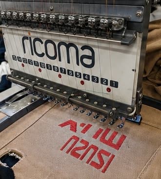 Embroidery machine stitching a logo